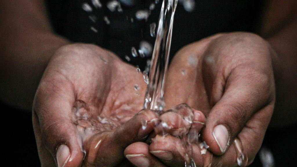 Hands catching clean flowing water