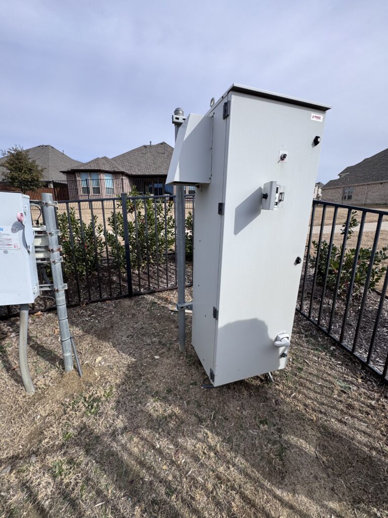 Outdoor well control cabinet installed near residential homes
