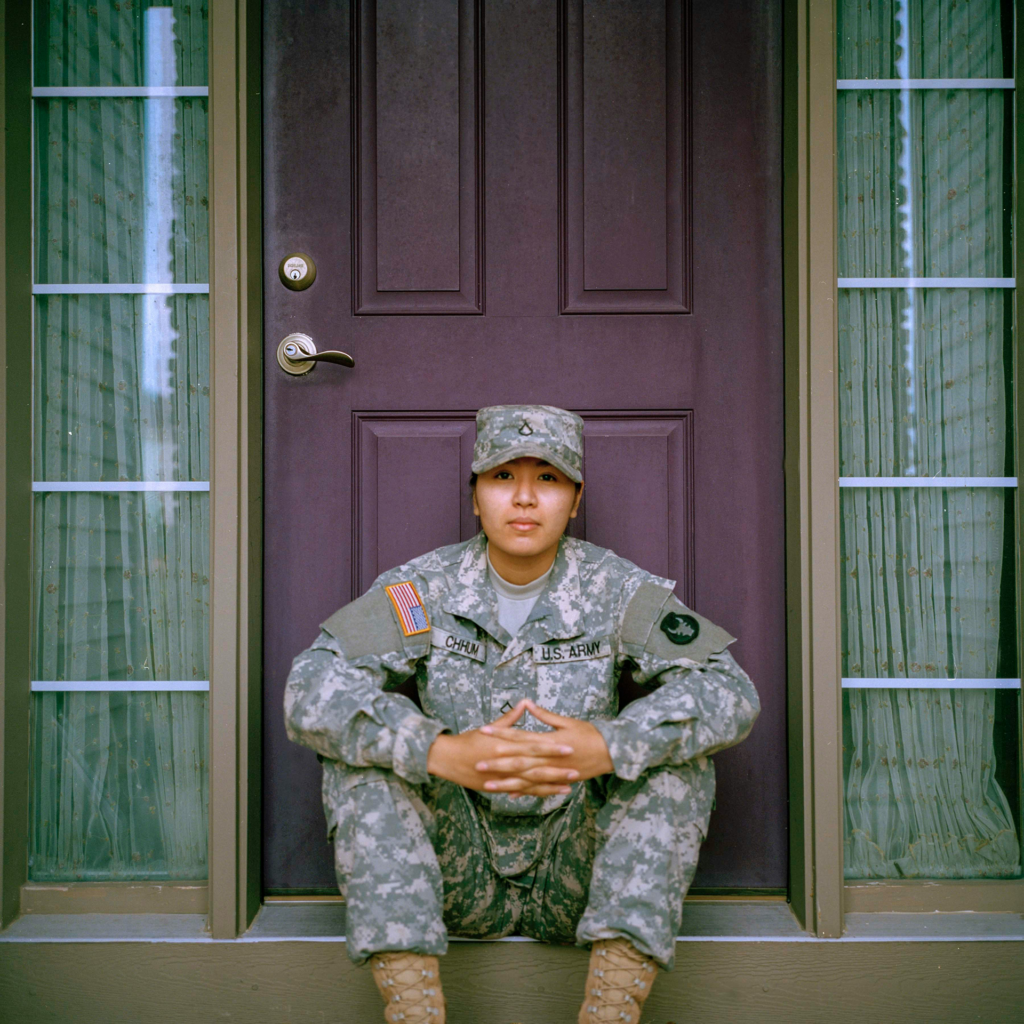 Veteran seated at front door of home